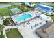 Aerial view of the community pool area with lounge chairs, tiki bar, and well-maintained grounds at 617 Cervina S Dr, Venice, FL 34285