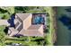 Aerial view of the property featuring a screened-in pool and pristine landscaping at 7340 Barclay Ct, University Park, FL 34201