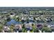 Aerial view of a luxury home with swimming pool surrounded by trees, ponds, and other homes at 7340 Barclay Ct, University Park, FL 34201