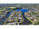 Aerial view of a waterfront community with homes surrounding a beautiful lake at 7340 Barclay Ct, University Park, FL 34201