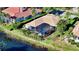 Aerial view of a beautiful home with a screened-in pool overlooking a serene pond at 7340 Barclay Ct, University Park, FL 34201