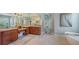 Elegant bathroom with dual sinks, granite countertops, and a vanity area, accented by decorative lighting at 7340 Barclay Ct, University Park, FL 34201