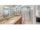 Elegant bathroom showcasing a granite countertop, gold-framed shower, and access to a bedroom at 7340 Barclay Ct, University Park, FL 34201