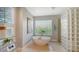 Stylish bathroom featuring a freestanding tub and a unique glass block shower, creating a spa-like retreat at 7340 Barclay Ct, University Park, FL 34201