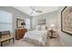 Bright bedroom featuring a queen bed, dresser, ceiling fan, and natural light at 7340 Barclay Ct, University Park, FL 34201