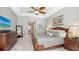 Tranquil main bedroom with soft gray tones, tray ceiling, and stylish furniture at 7340 Barclay Ct, University Park, FL 34201