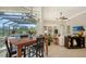 Bright dining room features a wooden table, black chairs, and views of the backyard pool at 7340 Barclay Ct, University Park, FL 34201
