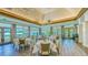 Spacious dining room with soaring ceilings, elegant lighting and large windows offering abundant natural light at 7340 Barclay Ct, University Park, FL 34201