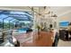 Dining room with a wooden table, seating for six, and views of the backyard pool at 7340 Barclay Ct, University Park, FL 34201