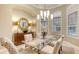 Dining room with elegant lighting fixture, designer rug, and views from the large windows at 7340 Barclay Ct, University Park, FL 34201