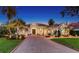 Elegant home featuring a terracotta-tiled roof, lush landscaping, and a spacious driveway with curb appeal at 7340 Barclay Ct, University Park, FL 34201