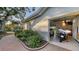 Garage exterior shot, showing space for multiple vehicles and a side-mounted motorcycle at 7340 Barclay Ct, University Park, FL 34201