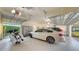 This well-lit garage has epoxy floors and space for multiple vehicles and storage at 7340 Barclay Ct, University Park, FL 34201