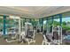 Bright gym room with several workout stations and floor to ceiling windows overlooking the community at 7340 Barclay Ct, University Park, FL 34201