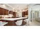 Spacious kitchen boasts dark wood cabinetry, stainless appliances, white countertops and recessed lighting at 7340 Barclay Ct, University Park, FL 34201