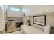 Well-lit laundry room featuring modern washer and dryer with white cabinets and counter space for added convenience at 7340 Barclay Ct, University Park, FL 34201
