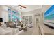Comfortable living room featuring built-in shelving, large windows, and neutral tones for a relaxed atmosphere at 7340 Barclay Ct, University Park, FL 34201