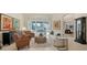 Bright living room featuring neutral tones, comfortable seating, and sliding glass doors to pool at 7340 Barclay Ct, University Park, FL 34201
