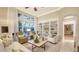 Cozy living room featuring natural light, built-in shelving, and comfortable seating at 7340 Barclay Ct, University Park, FL 34201