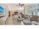 Bright living room featuring tile floors, neutral furnishings, and sliding glass doors to an outdoor space at 7340 Barclay Ct, University Park, FL 34201