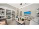 Comfortable living room with built-in bookshelves, tile floors, and neutral tones at 7340 Barclay Ct, University Park, FL 34201