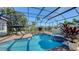 Inviting backyard screened pool with a spa and lounge chairs, perfect for enjoying the Florida sunshine at 7340 Barclay Ct, University Park, FL 34201