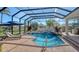 Sparkling pool with spa, tanning ledge, and screened enclosure overlooking the backyard pond at 7340 Barclay Ct, University Park, FL 34201