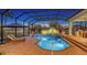Backyard screened pool with a spa and lounge chairs, perfect for enjoying the Florida sunshine at 7340 Barclay Ct, University Park, FL 34201