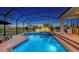 Relaxing screened-in pool area with spa and views of the lush green surroundings at 7340 Barclay Ct, University Park, FL 34201
