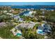 Breathtaking aerial view of a waterfront community showcasing beautiful homes, lush landscaping, and sparkling pools at 749 Tropical Cir, Sarasota, FL 34242