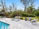Inviting pool area with comfortable lounge chairs, seating, and lush landscaping at 749 Tropical Cir, Sarasota, FL 34242