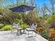 Backyard patio with comfortable seating under the shade of an umbrella at 749 Tropical Cir, Sarasota, FL 34242