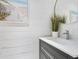 Modern powder room with shiplap walls, vessel sink, and decorative wall art at 749 Tropical Cir, Sarasota, FL 34242