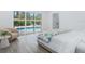 Bright bedroom with pool view, features light hardwood floors and modern furniture at 749 Tropical Cir, Sarasota, FL 34242