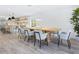 Bright, open concept dining room with modern light fixture, stylish chairs, and hardwood floors at 749 Tropical Cir, Sarasota, FL 34242