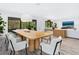 Elegant dining area with large windows, modern lighting, and stylish decor at 749 Tropical Cir, Sarasota, FL 34242