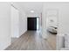 Bright foyer with modern finishes, wood floors, and a view of the living space at 749 Tropical Cir, Sarasota, FL 34242