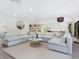 Open-concept living room with a plush sofa and lots of natural light at 749 Tropical Cir, Sarasota, FL 34242