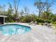 Relaxing backyard pool area with comfortable lounge chairs and lush landscaping at 749 Tropical Cir, Sarasota, FL 34242
