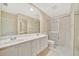 Bathroom featuring double sinks, and glass shower doors at 7655 Pesaro Dr, Sarasota, FL 34238