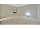 Neutral bedroom with carpet, a window, and a decorative lamp at 7655 Pesaro Dr, Sarasota, FL 34238