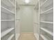 Walk-in closet with built-in shelving on both sides at 7655 Pesaro Dr, Sarasota, FL 34238