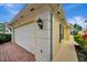A side view of the home and garage that shows the brick driveway at 7655 Pesaro Dr, Sarasota, FL 34238