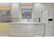 Bright kitchen featuring white appliances and lots of natural light at 7655 Pesaro Dr, Sarasota, FL 34238