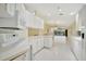 This is an open layout of a kitchen with a counter looking to the living room, all in white at 7655 Pesaro Dr, Sarasota, FL 34238