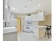 Bright kitchen with white cabinets and bar seating area at 7655 Pesaro Dr, Sarasota, FL 34238