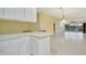 Open layout of a kitchen with a large counter looking to the living room at 7655 Pesaro Dr, Sarasota, FL 34238