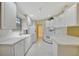 Clean, white kitchen featuring modern appliances, ample cabinet space, and an open layout for easy entertaining at 7655 Pesaro Dr, Sarasota, FL 34238