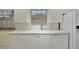 Bright kitchen area with a white sink, stainless steel faucet, and dishwasher at 7655 Pesaro Dr, Sarasota, FL 34238