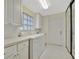 Bright laundry room with modern appliances and ample cabinetry at 7655 Pesaro Dr, Sarasota, FL 34238